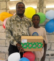 Seen here Pastor Anous Nordeus the founder of Maranatha Ministries distirbuting the Make Jesus Smile shoeboxes to the orphans. 