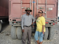 Pastor Banes with Lady Mary Beckles from Holy Seed International outside of the container.