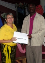 Gwalughano Mwalusamba was trained in KIMI in Mbeya, seen here receiving his Child Evangelism curriculum from Jenny