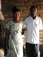 Pastor David with one of the graduates in her home
