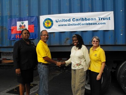 United Caribbean Trust founder Jenny Tryhane and Greta St Hill receive the container for Haiti following the earthquake