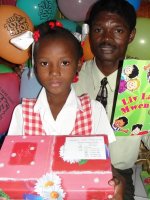 Seen here Pastor Banes the Haiti Kids' EE Director distirbuting the Make Jesus Smile shoebox gifts wrapped and packed by the children of Barbados.