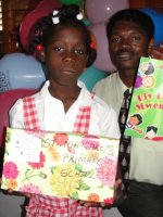 Child at Bethesda school receiving her gift