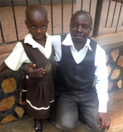 Charity seen here with her new dad - Pastor Abraham on her first day at school - praise God.