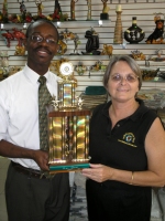 Jenny Tryhane, Founder of United Caribbean Trust with the Manager of Sewing World with the winning trophy