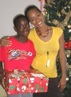 Seen here the children o receiving their Make Jesus Smile Christmas shoebox gifts packed by the children of Barbados.