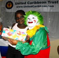 A child in Haiti receiving a Make Jesus Smile shoebox wrapped and packed by a child at Hawthorne Methodist Church. 