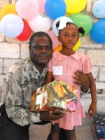 Pastor Anous Nordeus distirbuting the Make Jesus Smile shoeboxes to the children of the Maranatha school