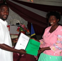 This Pastor receiving her manual and curriculumm from Pastor David was one of the House of Freedom Women's Empowerment program and she is excited about introducing the program into her local schools.