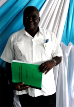 Bishop seen at Tanzania Calvary Tabernacle Church receiving his KIMI curriculum.