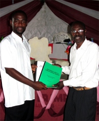 Bishop Enock Phil Mwambipile seen here receiving his KIMI curriculum from Pastor David.