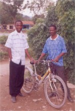 Pastor Lotie and Pastor William seen here with the mountain bike donated by UCT to start the Youth Alert AIDS educational program at Liberty School.