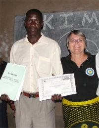 God raised up a teacher, Patrick, to assist Pastor Paul coordinate the KIMI program in this region, seen here with Jenny Tryhane his teacher presenting him with his KIMI curriculum.