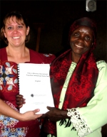Pastor Abraham's mother receiving her KIMI curriculum and certificate