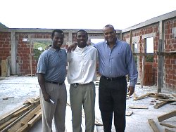 Pastor Happy (centre) in the new church with Mylon Wason (left) and Michael Chandler (right) from Milan Co Ltd, the UCT Project Planner,