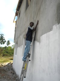 Sammy seen here, age 12 painting the back of the church
