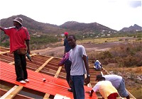 YWAM helping with the roof as part of their decipleship outreach missions programme